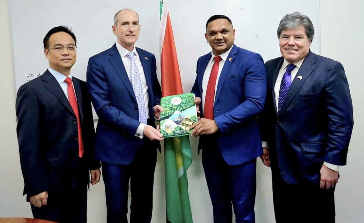 Minister of Natural Resources Vickram Bharrat (second from right) hands over to President of ExxonMobil Guyana, Alistair Routledge, the signed petroleum production licence for Guyana’s fifth offshore development, Uaru. They are joined by Production Manager of CNOOC Guyana  Xu Xiangdong (left) and Hess Corporation’s Vice President of Exploration, Appraisal, and Developments for Guyana and Suriname, Tim Chisholm.  (MNR photo)

