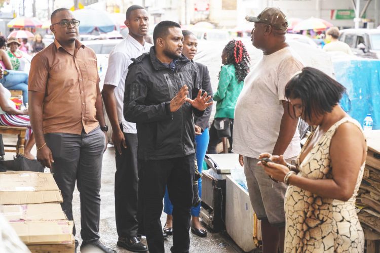 Minster of Local Government and Regional Development, Nigel Dharamlall engaging vendors along Regent Street