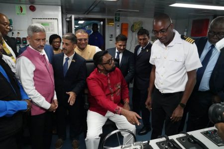 President Irfaan Ali being given some instructions on the operation of the newly commissioned vessel while Indian External Affairs Minister  Dr Subrahmanyam Jaishankar among others look on. (Minister Indar Deodat’s photo)