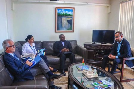 Head of National Office for Guyana, Henri-Sylvian Yakara (third left) and other representatives of the UN agency meeting with Foreign Secretary, Robert Persaud (right) (DPI photo)