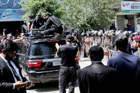Pakistan security forces guard a vehicle carrying former Prime Minister Imran Khan after his arrest at a court in Islamabad, Pakistan, May 9, 2023. REUTERS/Stringer NO RESALES. NO ARCHIVES.