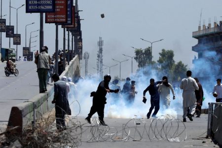 Supporters of Pakistan's former Prime Minister Imran Khan throw stones towards police during a protest against Khan's arrest, in Peshawar, Pakistan, May 10, 2023. REUTERS/Fayaz Aziz