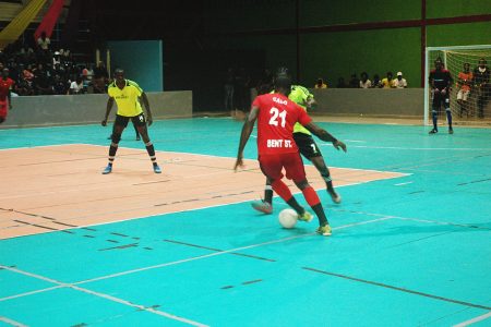 Colin Nelson of Bent Street in the process of dribbling Bevney Marks of Stabroek Ballers
