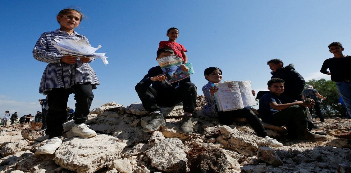 Palestinian students show damaged books after Israeli machinery demolish a school near Bethlehem in the Israeli-occupied West Bank May 7,2023. (Reuters photo)