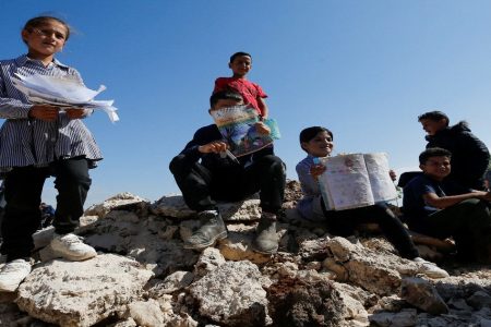Palestinian students show damaged books after Israeli machinery demolish a school near Bethlehem in the Israeli-occupied West Bank May 7,2023. (Reuters photo)