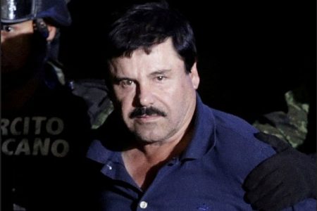 Recaptured drug lord Joaquin "El Chapo" Guzman is escorted by soldiers at the hangar belonging to the office of the Attorney General in Mexico City, Mexico January 8, 2016. (Reuters photo)