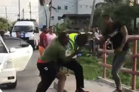 Civilians  assaulting a traffic officer at Turkeyen access road