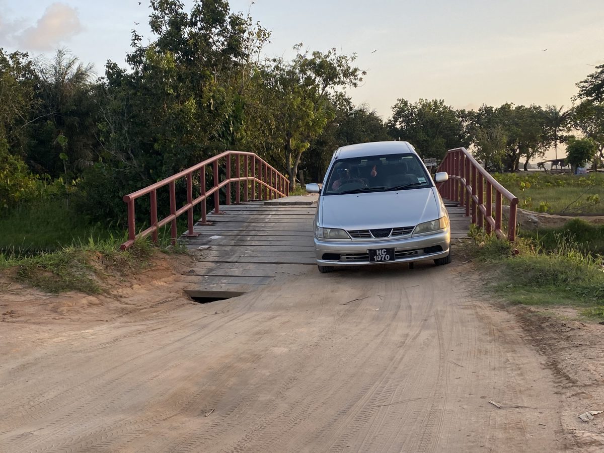  A vehicle crosses the bridge with the hole evident 