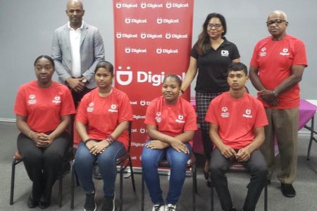 President of the Guyana Olympic Association, Godfrey Munroe, left, Digicel’s Guyana Communications Manager, Vidya Sanichara and Wilton Spencer, President of Special Olympics Guyana, right, along with three of the athletes and coach pose for a photo following yesterday’s presentation. 
