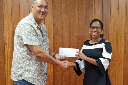 Secretary-General of the Guyana Olympic Association, Vidushi Persaud-McKinnon hands over sponsorship cheque to David Fernandes, President of the Guyana Squash Association.