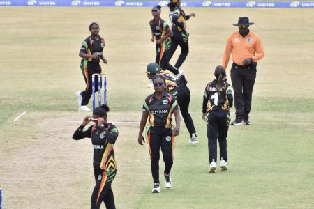 Guyana women players celebrate the fall of a Jamaican batswoman’s wicket