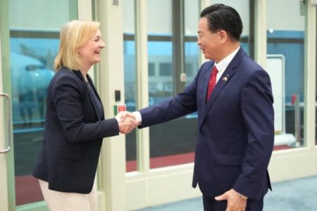 Taiwan’s Foreign Minister Joseph Wu and Former British Prime Minister Liz Truss shake hands upon her arrival at Taoyuan International Airport, in Taoyuan, Taiwan, in this handout released on May 16, 2023. Ministry of Foreign Affairs of Taiwan/Handout via REUTERS