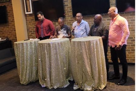 Dexter `DeKid’ Marques, second from left, yesterday signed his contract to fight Colombian Luis Carrilo at the 704 Sports Bar, Albert and  Lamaha Streets.
