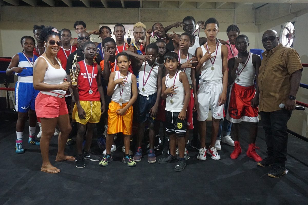 The boxers along with Shondell Alfred Guyana Boxing Association (GBA) executive member, Seon Bristol pose for a photo at the conclusion of the Pepsi/Mike Parris School Boys/ Juniors championships at the Andrew ‘Sixhead’ Lewis Gym yesterday.(Emmerson Campbell photo)