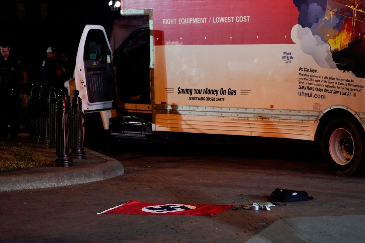 A Nazi flag and other objects recovered from a rented box truck are pictured on the ground as the U.S. Secret Service and other law enforcement agencies investigate the truck that crashed into security barriers at Lafayette Park across from the White House in Washington, U.S. May 23, 2023.   REUTERS/Nathan Howard