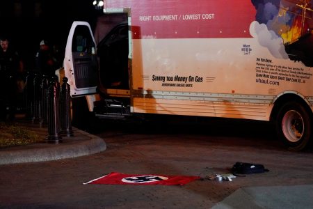 A Nazi flag and other objects recovered from a rented box truck are pictured on the ground as the U.S. Secret Service and other law enforcement agencies investigate the truck that crashed into security barriers at Lafayette Park across from the White House in Washington, U.S. May 23, 2023.   REUTERS/Nathan Howard