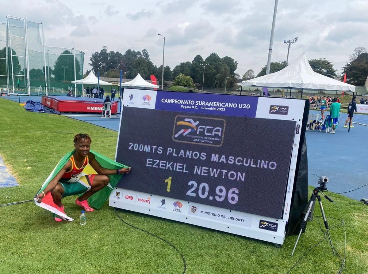 Ezekiel Newton, draped with the Golden Arrowhead, proudly poses alongside his gold medal run time of 20.96s in the 200m final