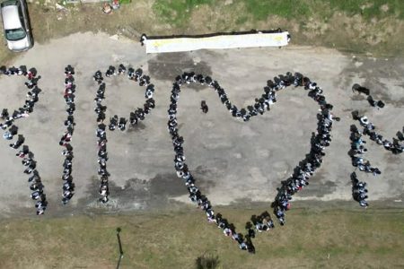 A sympathy display by North Ruimveldt students over the deaths of the 19 children.  (Ministry of Education photo)