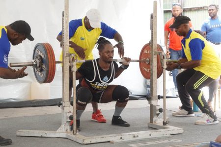 Kheon Evans squatting yesterday at Chase’s Academy. (Emmerson Campbell photo)