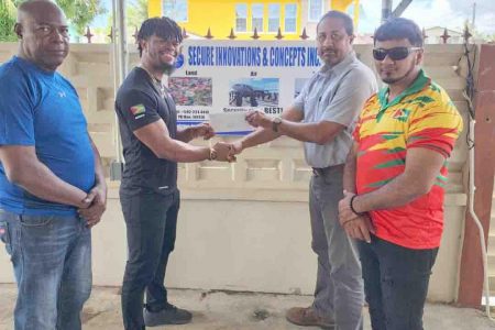 SIC Inc. Aviation Security Manager, Denzel Hopkinson (2nd left) hands over the cheque to Captain Dylan Fields in the presence of Lennox Brathwaite (left) and Roberto Tiwari. 