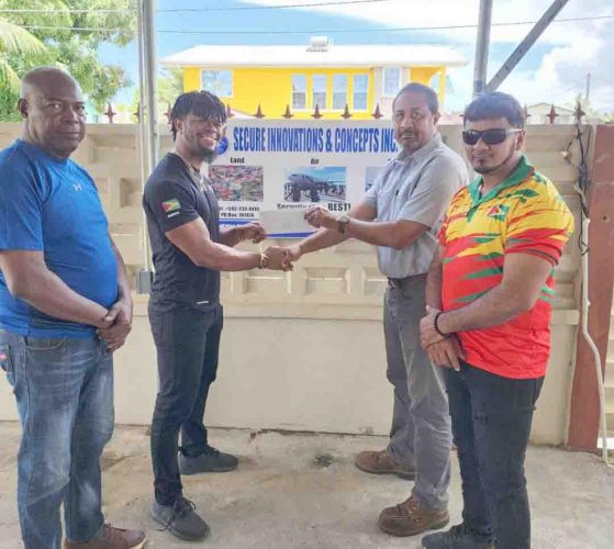 SIC Inc. Aviation Security Manager, Denzel Hopkinson (2nd left) hands over the cheque to Captain Dylan Fields in the presence of Lennox Brathwaite (left) and Roberto Tiwari. 