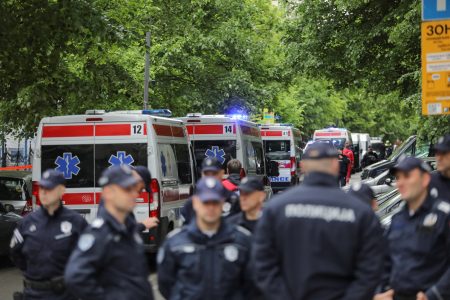 Police officers stand as a security guard died and at least five students were wounded after a schoolboy opened fire in a downtown Belgrade, Serbia, May 3, 2023. REUTERS/Djordje Kojadinovic