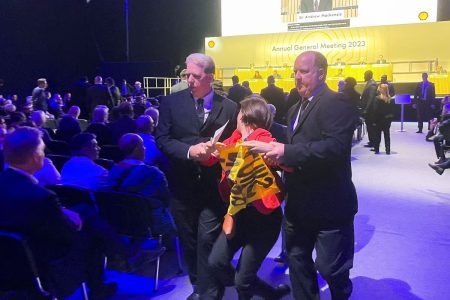 A climate activist is removed after disrupting Shell's annual general meeting in London, Britain May 23, 2023. REUTERS/Ron Bousso