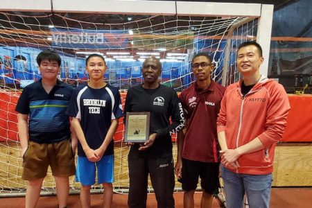 Former Caribbean men’s singles champion Guyanese Sydney Christophe displays the George Braithwaite award.
