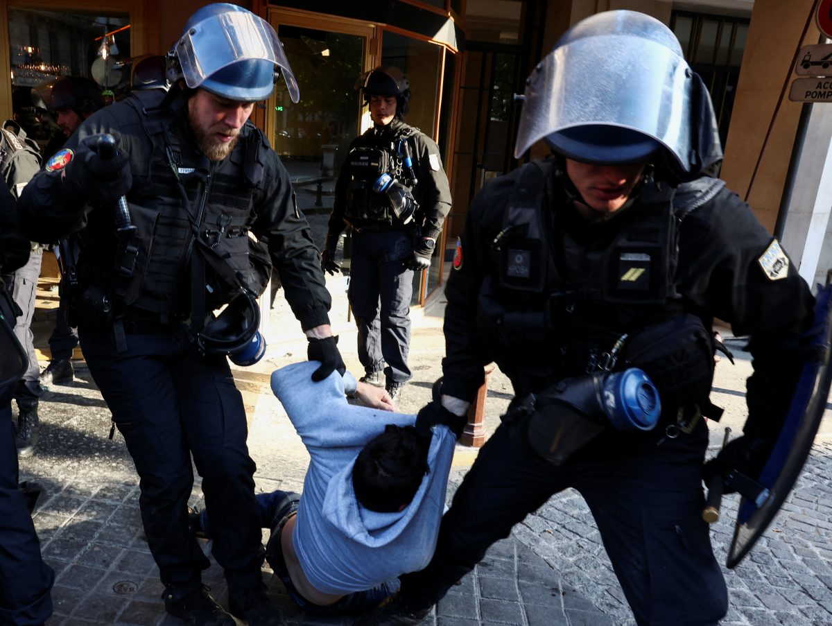 Police officers remove environmental activists during a protest against TotalEnergies and the East African Crude Oil Pipeline (EACOP) on the day TotalEnergies holds its annual shareholders meeting in Paris, France, May 26, 2023. REUTERS/Stephanie Lecocq