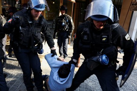 Police officers remove environmental activists during a protest against TotalEnergies and the East African Crude Oil Pipeline (EACOP) on the day TotalEnergies holds its annual shareholders meeting in Paris, France, May 26, 2023. REUTERS/Stephanie Lecocq