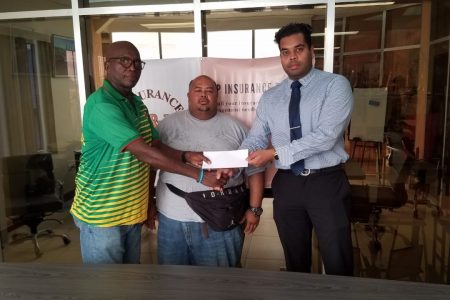 Vikash Panday of P&P Insurance Brokers hands over the
sponsorship cheque to Franklyn Victor. At centre is Troy Yhip.