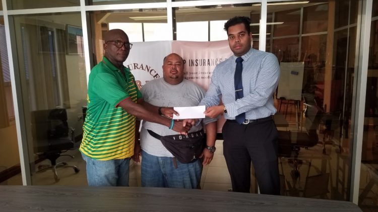 Vikash Panday of P&P Insurance Brokers hands over the
sponsorship cheque to Franklyn Victor. At centre is Troy Yhip.