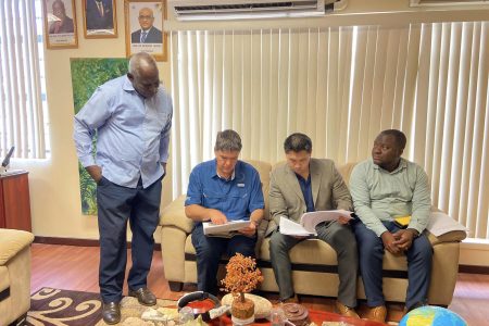 Minister Robeson Benn (left) and others meeting with the ATF representative. (Ministry of Home Affairs photo)