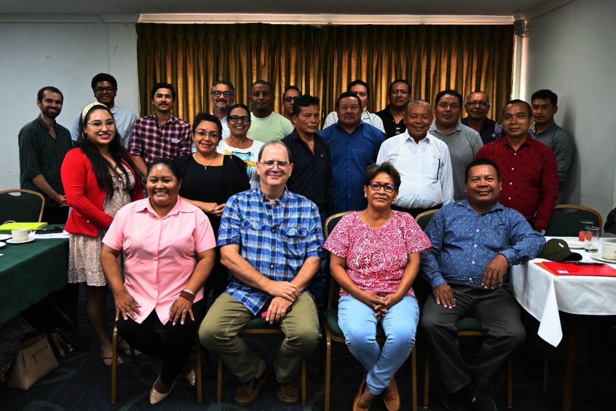 Seated from left are South Rupununi District Council’s Communications Officer Immaculata Casimero, Aster Global lead auditor  Kevin Markham, APA’s Executive Director  Jean La Rose, APA’s Treasurer  Earl Thomas. Standing at the back are representatives from the Moruca District Council, Upper Mazaruni District Council, North Pakaraimas District Council, ART Secretariat and other APA Executive Committee members and staff. 