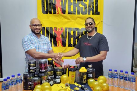 Managing Director of IPA Health Care, Reginald Persaud (left) presented a sponsorship pact to representative of the event, Faizal Bacchus.