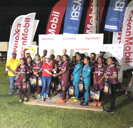 Waramuri skipper receives the female team’s championship trophy after they defeated President’s College in the final of the ExxonMobil U14 Football Championships.