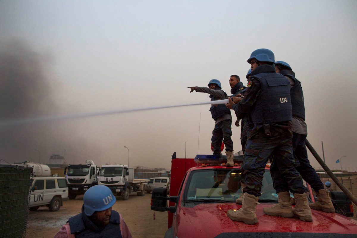 FILE PHOTO: United Nations peacekeepers at the MINUSMA base fight fires after a mortar attack in Kidal, Mali, June 8, 2017. Picture taken June 8, 2017. MINUSMA/Sylvain Liechti/Handout via REUTERS/File Photo
