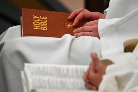 Delegates sit with copies of the Bible whilst attending the Church of England General Synod meeting in London, Britain, February 9, 2023. REUTERS/Toby Melville