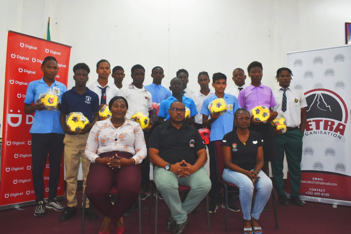 Representatives of the participating schools in the Georgetown leg
 of the Digicel Schools Championship displaying their footballs in the 
presence of members of the Petra Organization, the coordinators 
of the prestigious tournament
