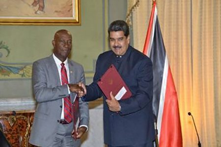 Prime Minister Dr Keith Rowley (left) shakes hands with Venezuela President Nicolas Maduro.