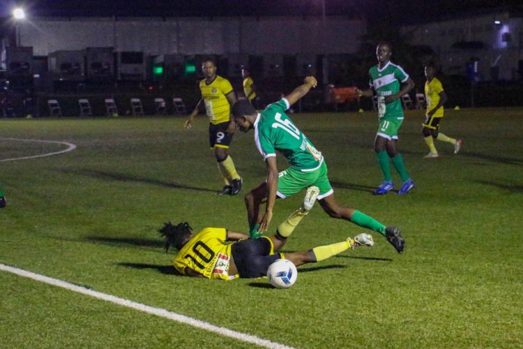 Michael Oie (left) of Western Tigers on the receiving end of a crunching tackle from a Den Amstel player in the KFC Elite League
