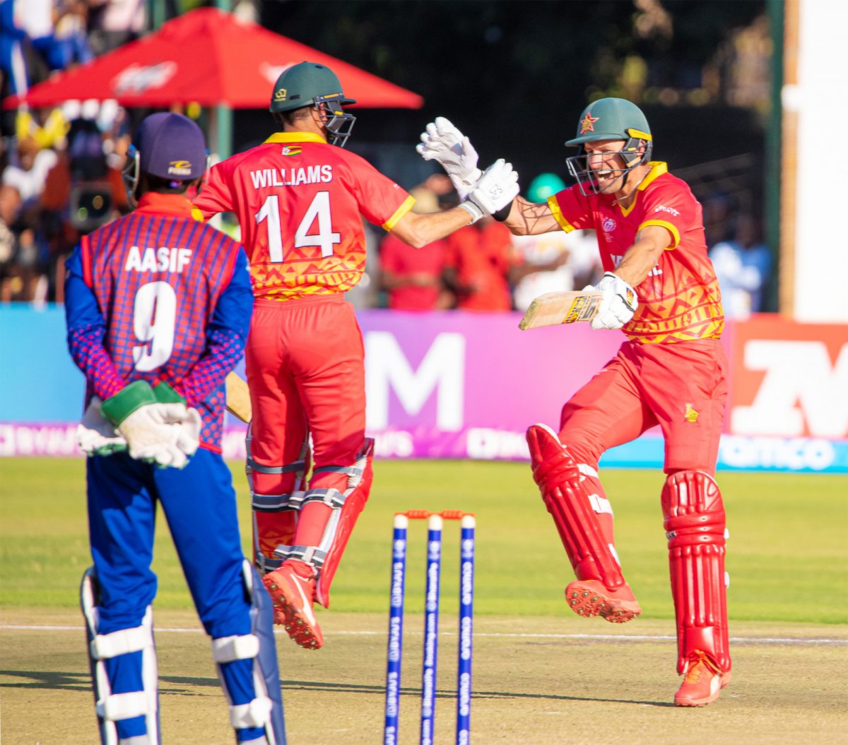 The Zimbabwe players  celebrate their win over Nepal.