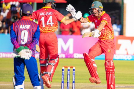 The Zimbabwe players  celebrate their win over Nepal.