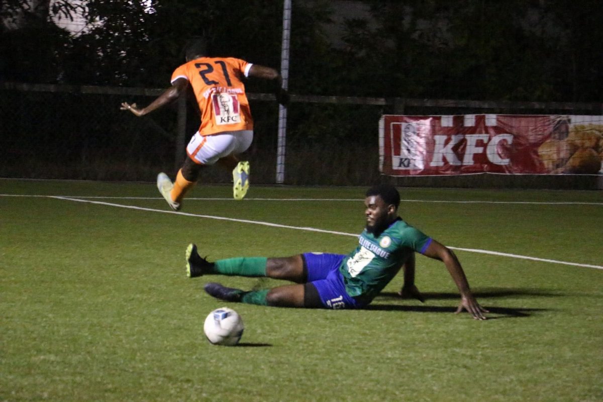 Inceford Charles (left) of Victoria Kings winning the ball with a successful challenge against a Fruta Conquerors player during the KFC Elite League.
