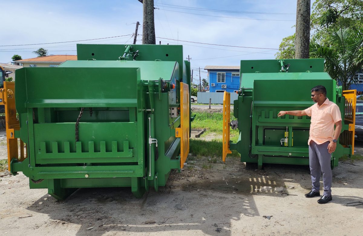 Mayor Ubraj Narine (right) with the two compactors (City council photo)