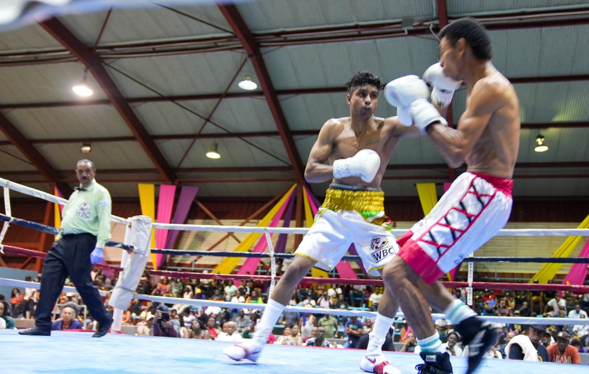 Guyana’s Elton Dharry on the attack en route to his unanimous decision win over Colombian journeyman Ronald ramos Saturday night at the National Gymnasium. (Photo courtesy Newsroom)
