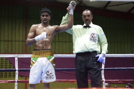 Referee, Eon Jardine raised the hand of Elton Dharry following his unanimous decision win over Colombian journeyman, Ronald Ramos on Saturday night.