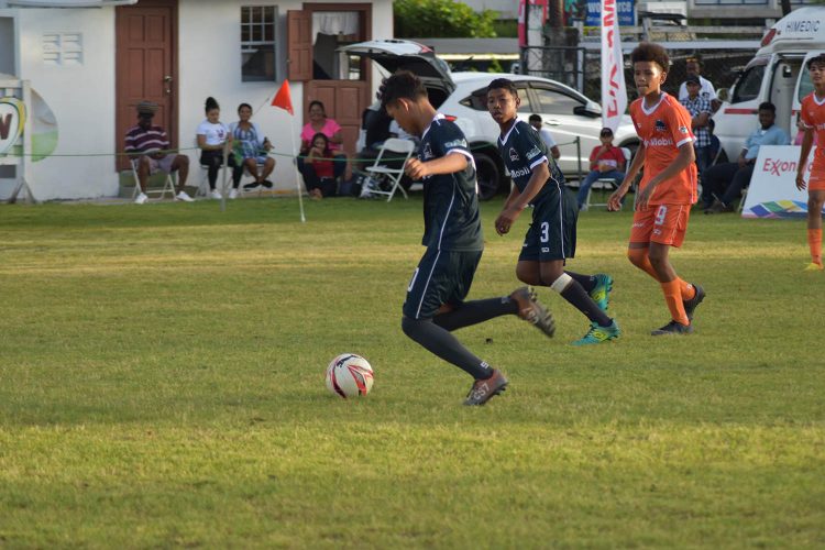 Part of the action between Tucville (green) and Queenstown on the opening day of the Digicel Schools Football Championship.
