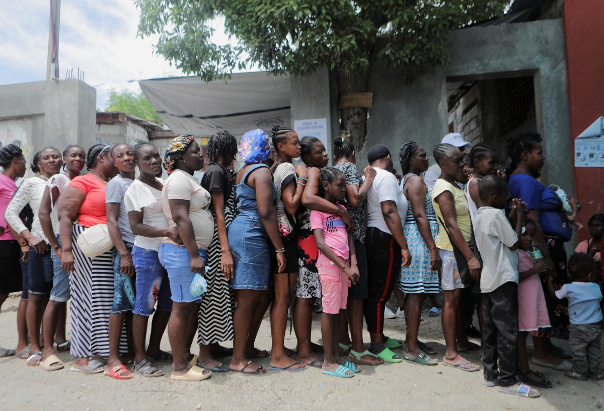 Women stand in line at the New Church of God of Deliverance camp for displaced people, which now harbors 120 families from various hard-hit neighborhoods since gangs have expanded their turf and now control communities accounting for some two million people, in Port-au-Prince, Haiti June 19, 2023. REUTERS/Ralph Tedy Erol