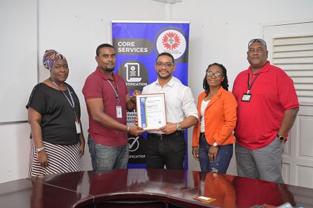 GPL Divisional Director, Gary Hall (centre) receives the GNBS Certificate from GNBS Technical Officer, Keon Rankin (second from left). Also in photo are GNBS Technical Officer Charissa Wilson (left) and GPL Senior Manager for HSE & Laboratory Services, Denise Griffith (second from right) and Quality Manager  Nigel Chetram. (GNBS photo)
